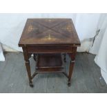 An Edwardian inlaid envelope card table of rectangular form on tapering rectangular legs with