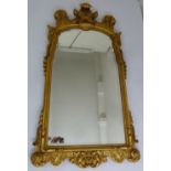 A shaped rectangular gilded wall mirror in mid 18th century style