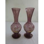 A pair of Victorian purple glass vases over painted white floral sprays