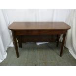 A mahogany D shape drop flap dining table on four rectangular legs