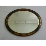 An oval wall mirror with Chinoiserie frame