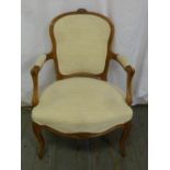 A late 19th century upholstered armchair on cabriole legs