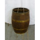 An oak barrel shaped umbrella stand with copper bands