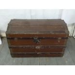 An early 20th century rectangular blanket box with arched hinged cover and side handles
