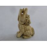 Late 19th century ivory netsuke of a seated dragon