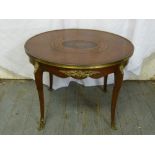 An oval Kingswood and mahogany inlaid occasional table on cabriole legs with cast metal claw feet