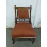 An oak ladies chair with upholstered seat on turned legs and original castors