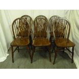 A set of six oak wheel back kitchen chairs