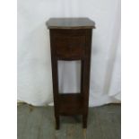 A rectangular mahogany plant stand with single drawer on four rectangular legs