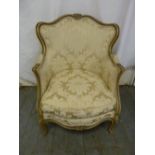 A 19th century Louis XVI style upholstered armchair, carved wood on four cabriole legs
