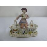 Meissen style sweetmeat dish in the form of a gentleman flanked by two baskets on raised oval