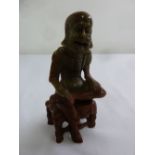 Chinese soapstone figurine of an elderly gentleman seated on a stool, 12cm (h)