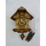 Black Forest cuckoo clock with hand painted flowers and leaves to include two weights and pendulum