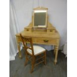 A rectangular pine dressing table with four drawers and swivel mirror on four turned legs and a