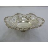 A Victorian silver fruit basket, flower and scroll border with pierced sides on raised base with