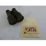 A pair of early 20th century military binoculars and an embroidered 1917 Souvenir de France