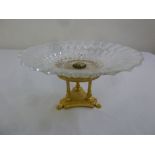 A glass and gilt metal circular fruit stand on raised triform base