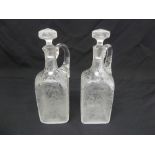 A pair of early 19th century Baccarat style glass claret jugs with drop stoppers