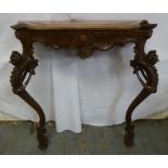 A Continental mahogany consol table with carved shell, mask and scrolls on cabriole legs