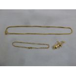 Two 18ct yellow gold chains and an 18ct gold charm, approx total weight 8.9g