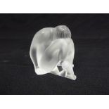 A Lalique frosted glass figurine of a seated lady, marks to the base, A/F