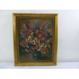 A framed oil on canvas still life of flowers, indistinctly signed bottom left, 60 x 48cm
