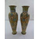 A pair of Doulton baluster vases decorated with stylised flowers and leaves circa 1910, one A/F