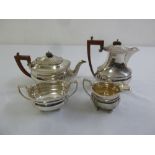 Four piece silver teaset rounded rectangular with angled handles to include teapot, water jug, sugar