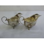 A pair of silver sauce boats with scroll handles on three pad feet, Birmingham 1932