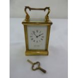 Mappin and Webb carriage clock with white enamel dial, Roman numerals and swing handle, to include
