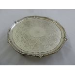 A George III silver tray with beaded border, the centre engraved with scrolls and leaves on three