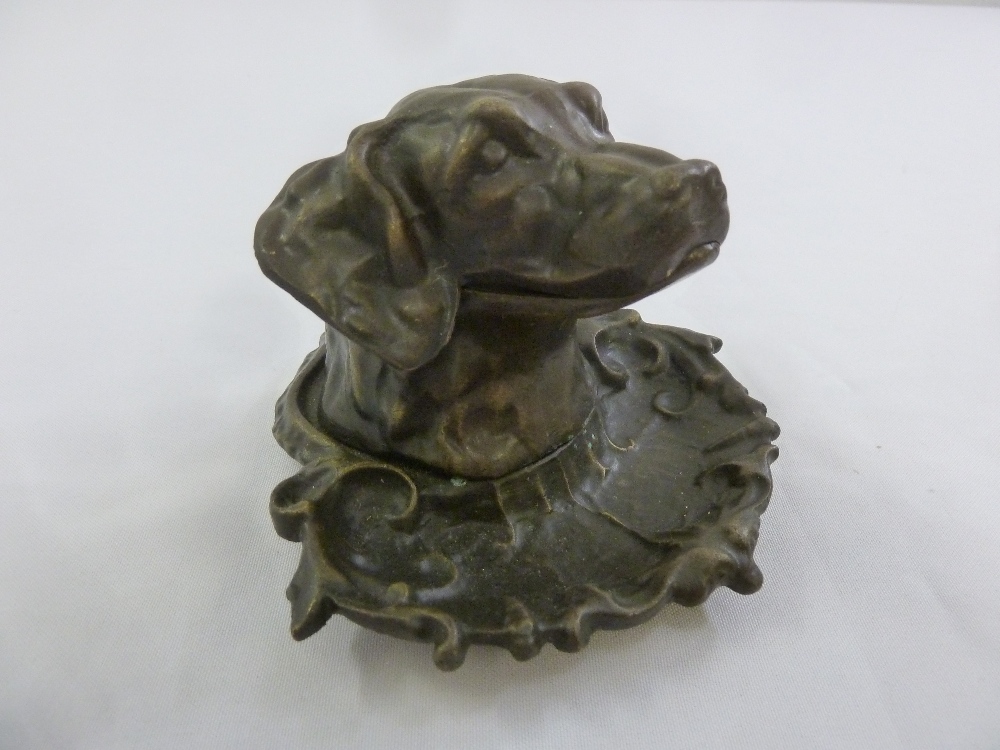 A bronze inkwell in the form of a dogs head