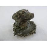 A bronze inkwell in the form of a dogs head