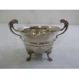 A silver sugar bowl with two lion mask cast double scroll handles on four lion mask paw feet,
