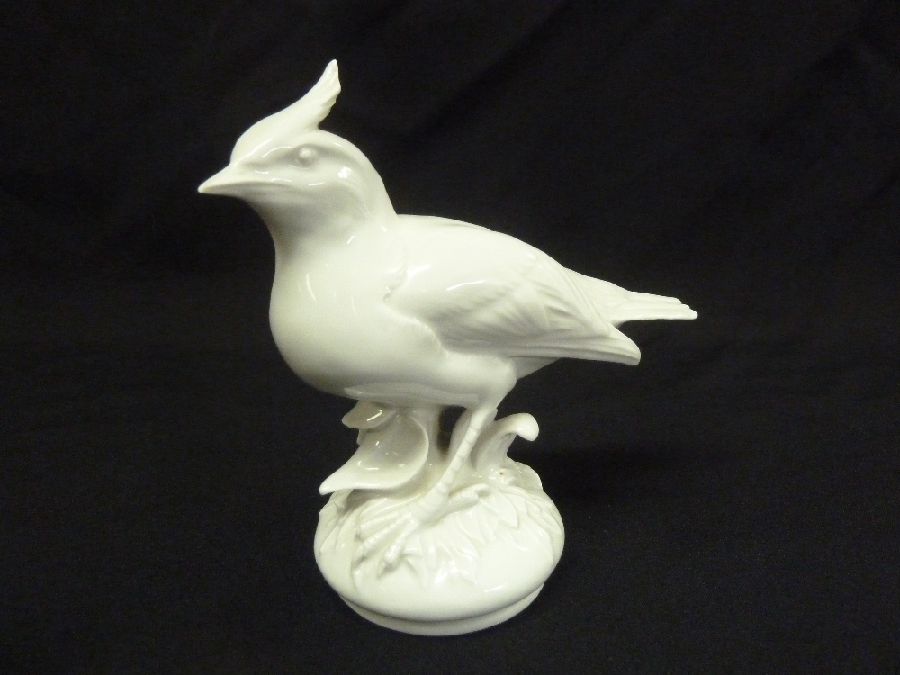 Meissen blanc de chine figurine of a bird on raised circular base, marks to the base