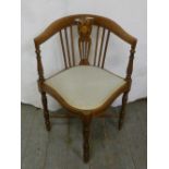 An Edwardian mahogany corner chair with inlaid panel and upholstered seat on turned legs