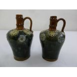 A pair of Royal Doulton green and brown glazed flagons