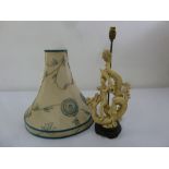 Chinese composition table lamp with a figurine of a man slaying a dragon, to include silk shade