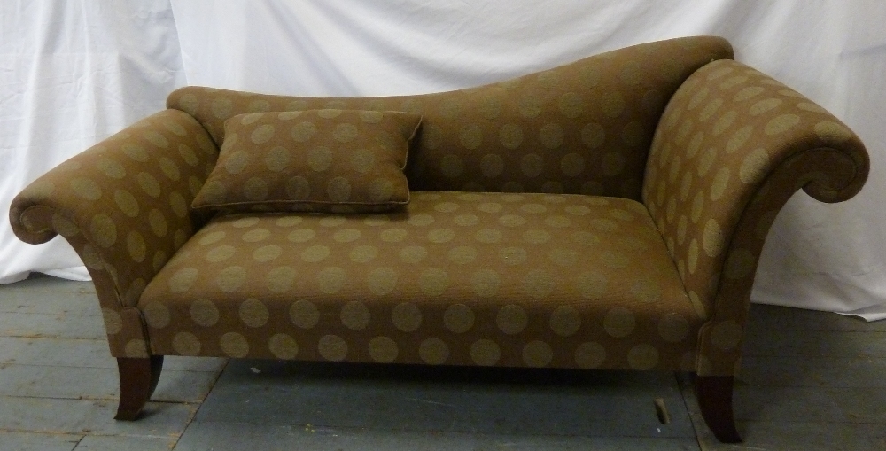 An upholstered chaise longue of customary form on four mahogany legs