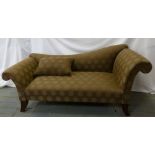 An upholstered chaise longue of customary form on four mahogany legs