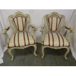A pair of early 20th century upholstered armchairs on cabriole legs