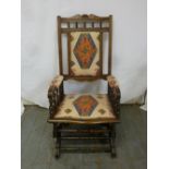 An early 20th century mahogany upholstered rocking chair