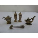 A three piece silver condiment set, a white metal toothpick holder in the form of a fish and a