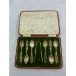 A cased set of six silver teaspoons and a matching pair of tongs
