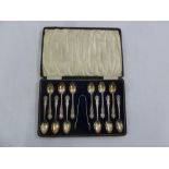 A cased set of twelve silver teaspoons and matching sugar tongs