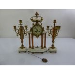 A French 19th century marble and gilt metal Defrais clock set with candelabra garnitures to