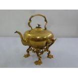 A Victorian brass tea kettle on decorative brass stand