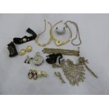 A quantity of costume jewellery to include necklaces, earrings, brooches and a stopwatch