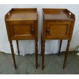A pair of mahogany bedside tables with hinged cupboards on turned tapering legs