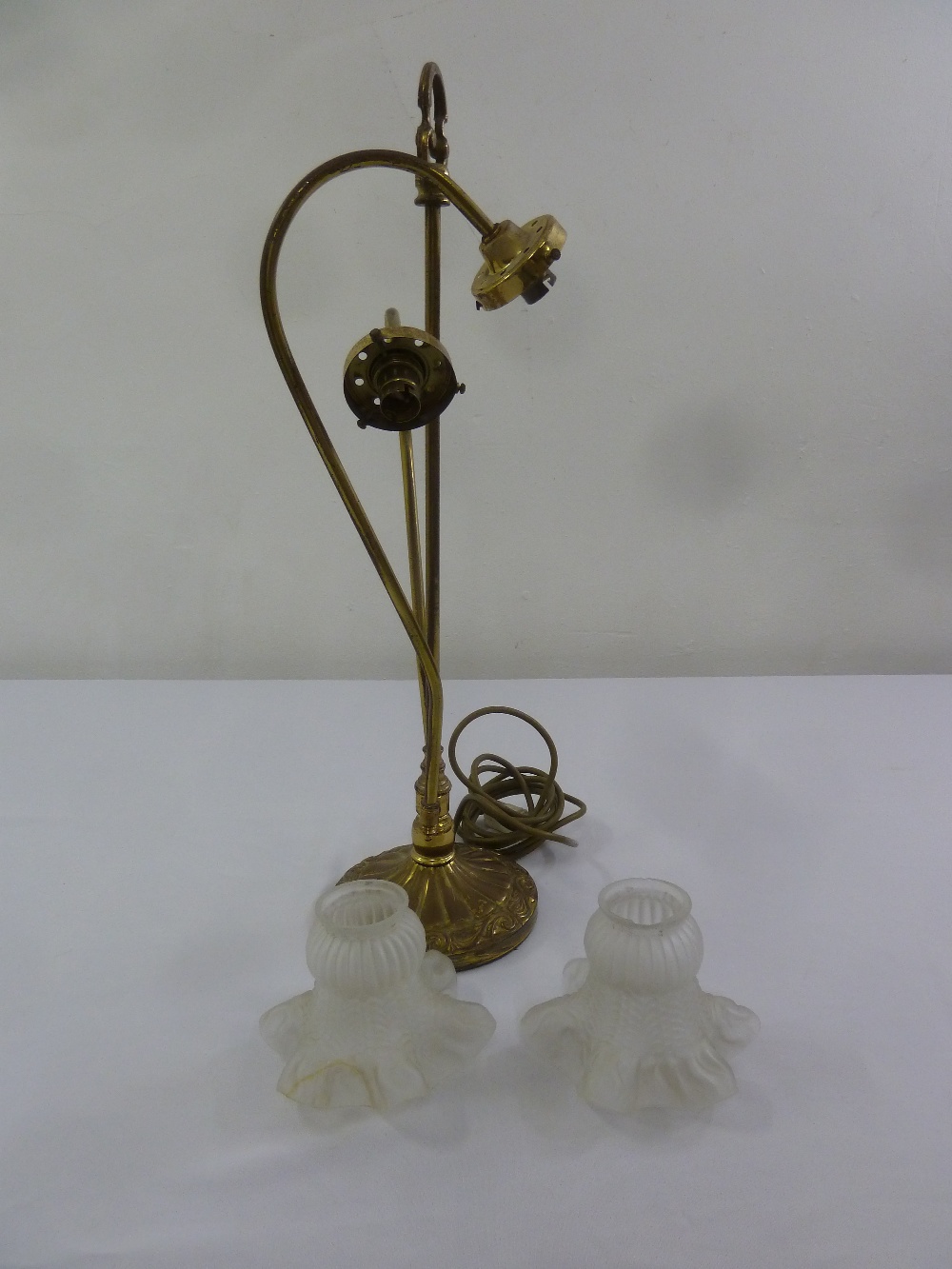 An Art Nouveau style brass table lamp with two frosted glass shades A/F